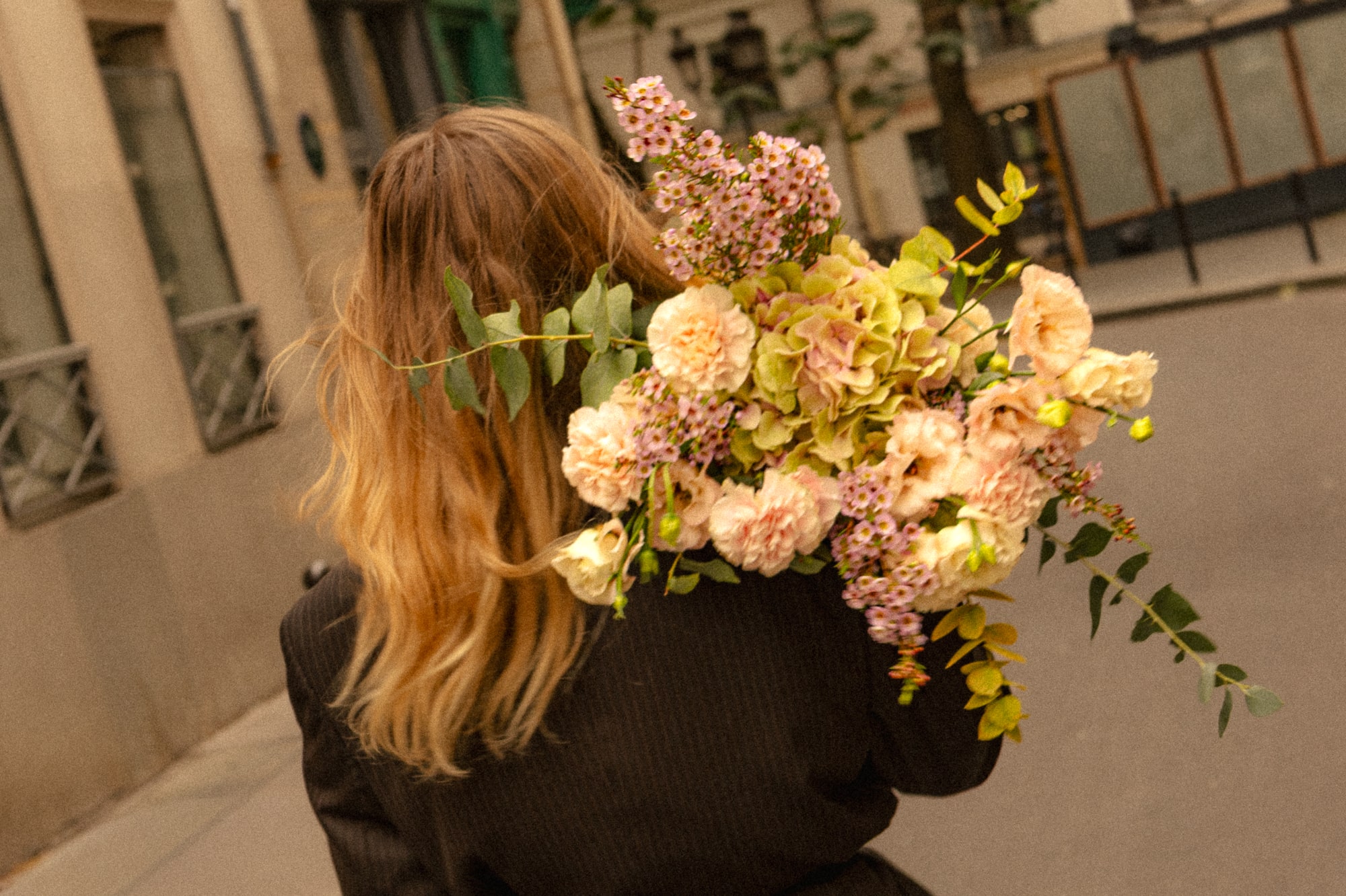 a woman carrying a bouquet of flowers