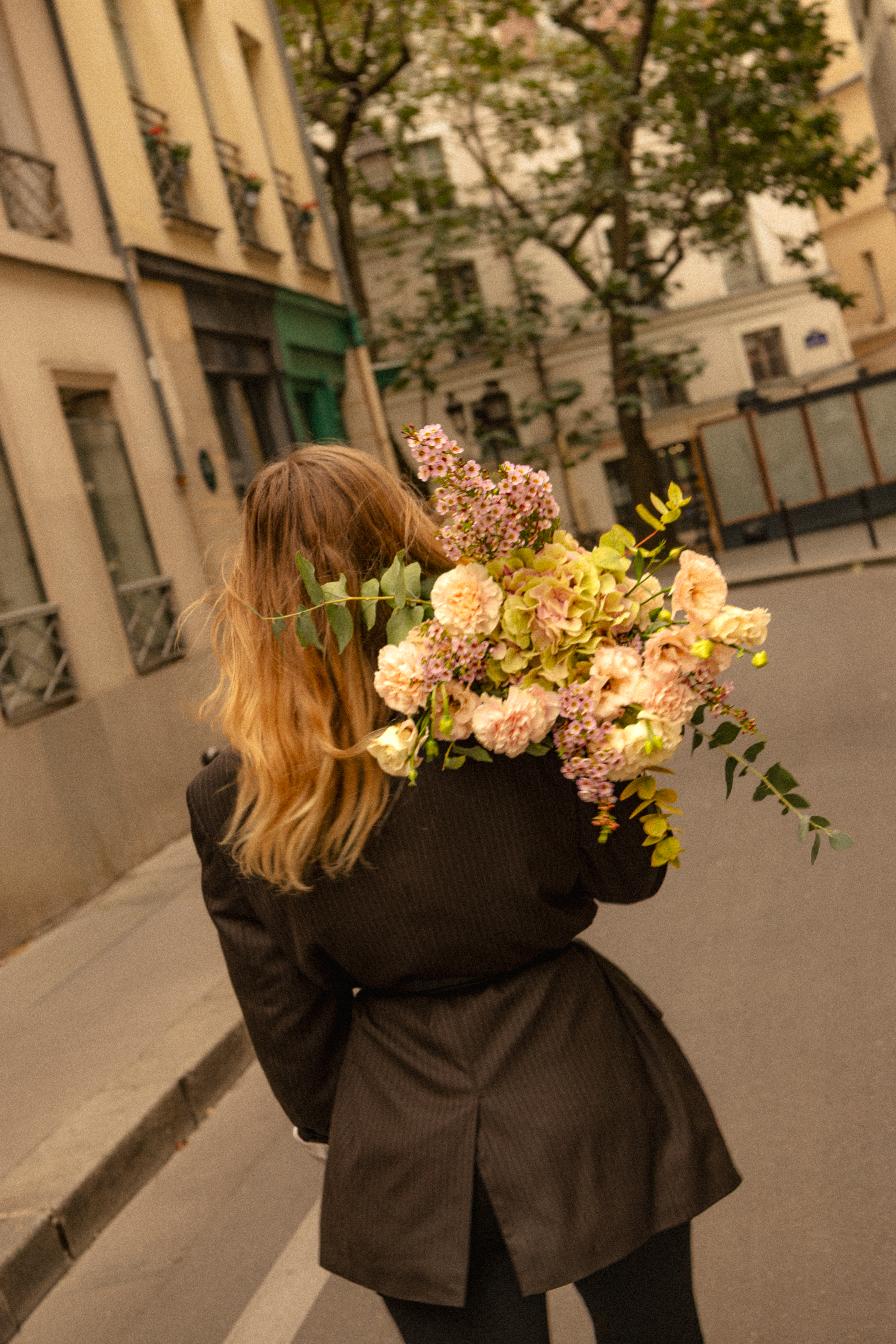 a woman carrying a bouquet of flowers