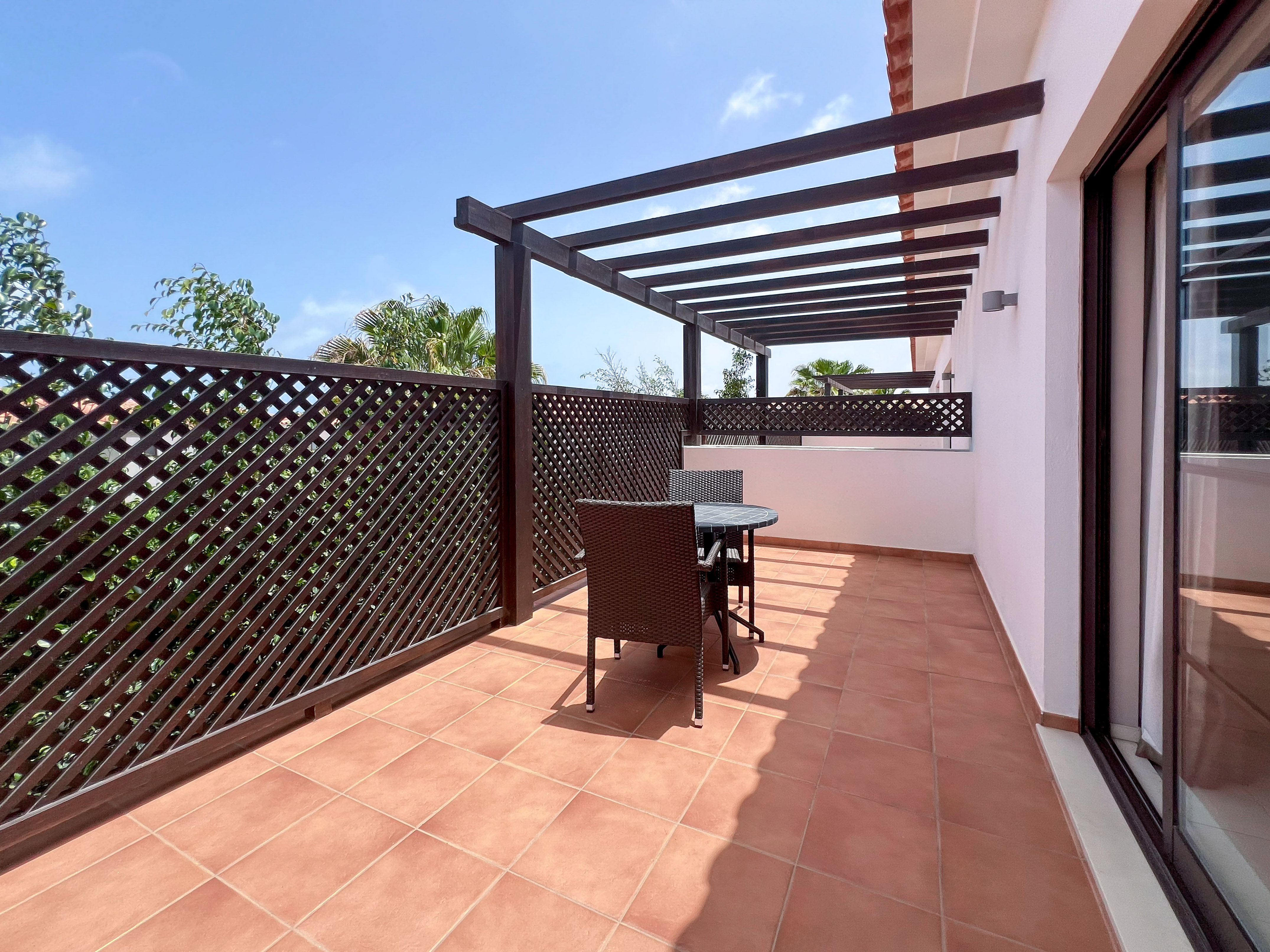 a patio with a table and chairs