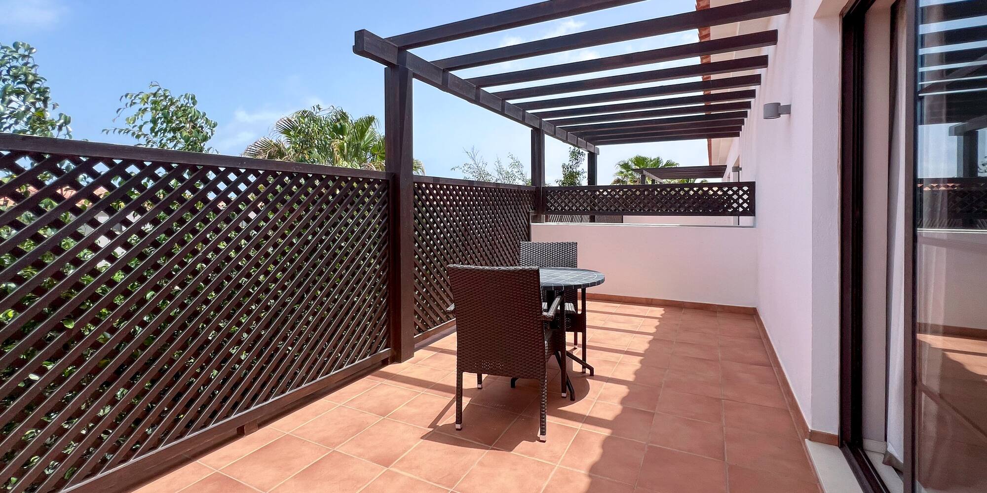a patio with a table and chairs
