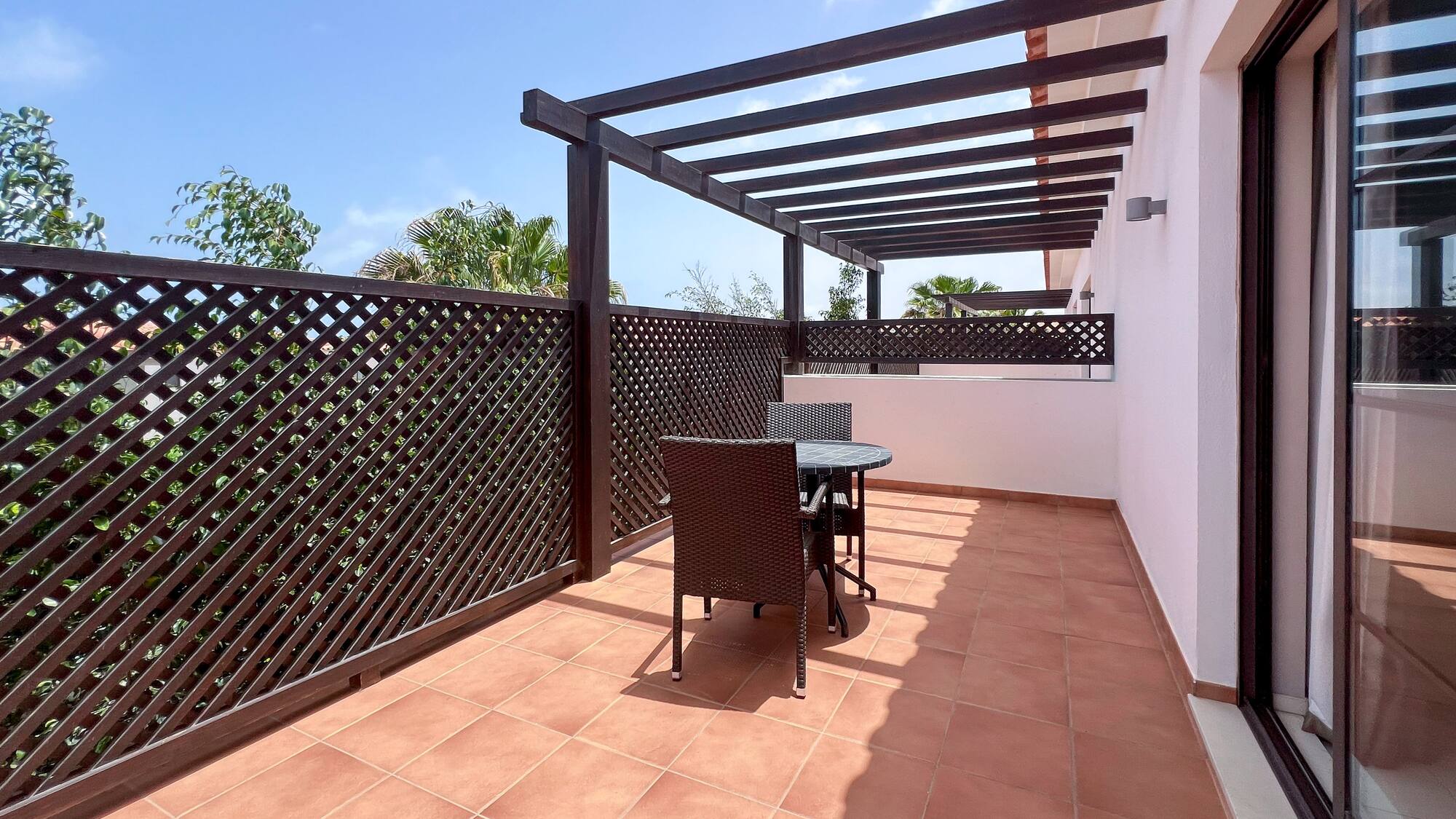 a patio with a table and chairs