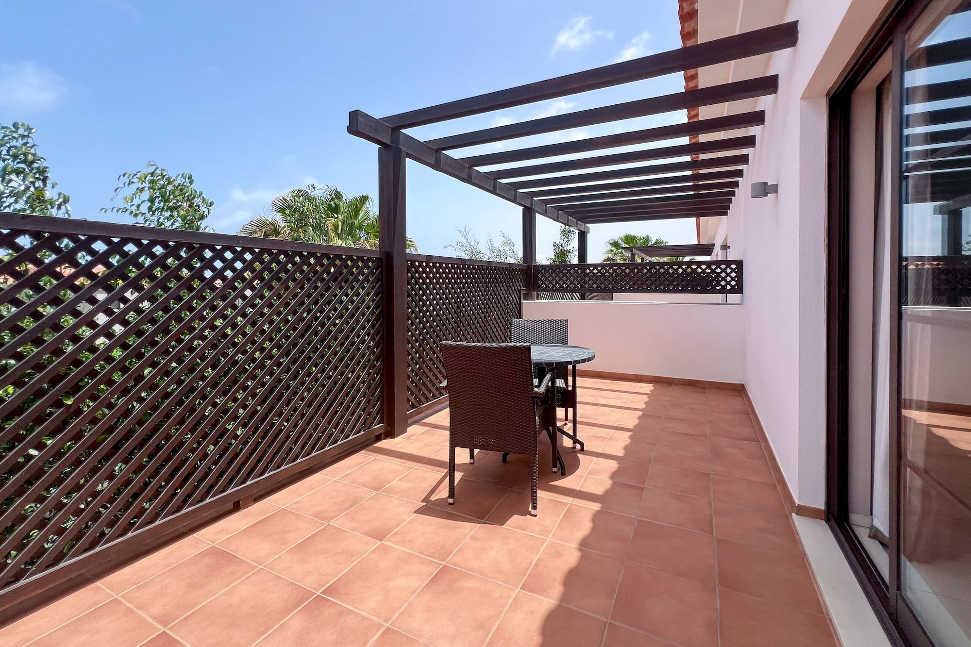 a patio with a table and chairs