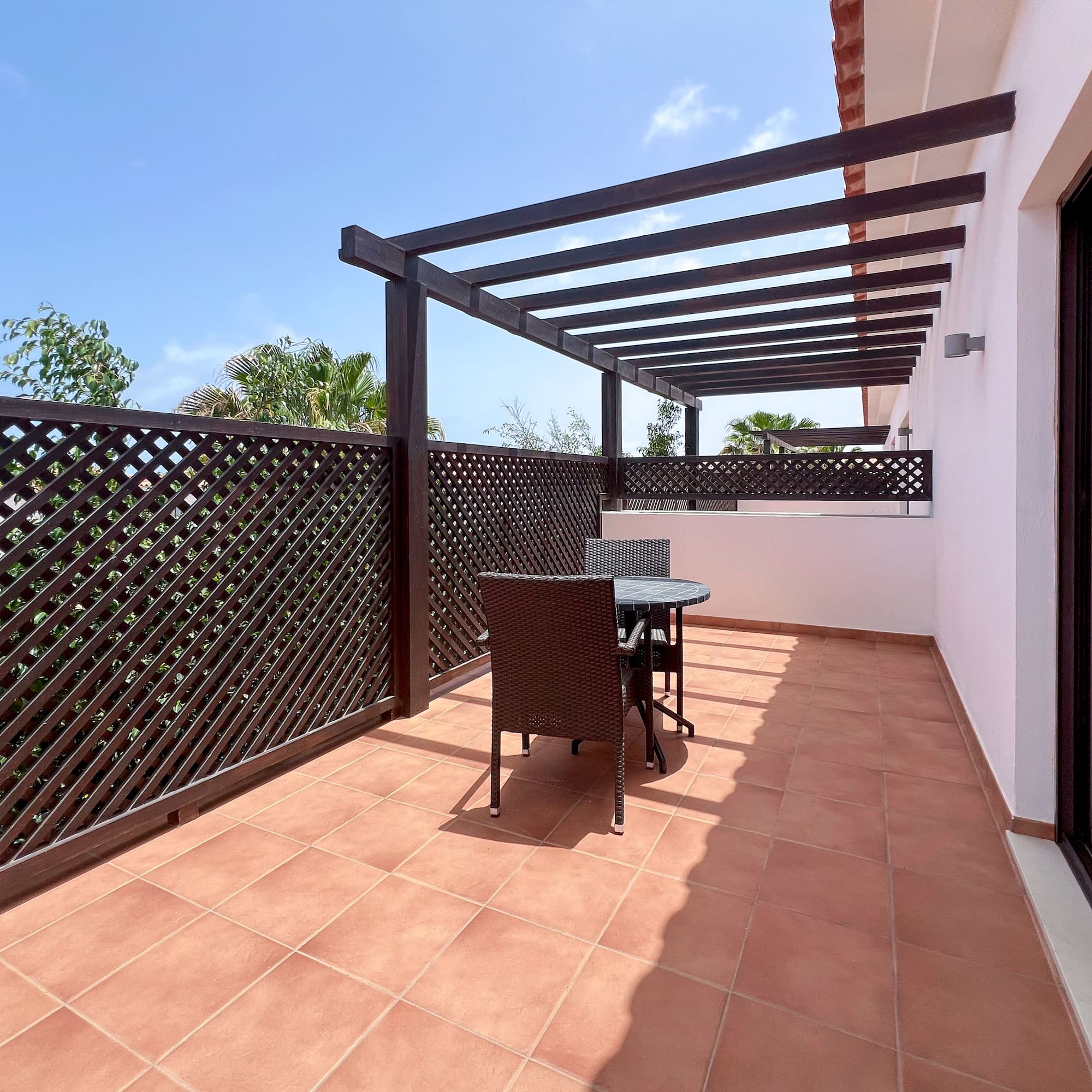a patio with a table and chairs