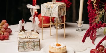 a cake on a plate with fruit and candles