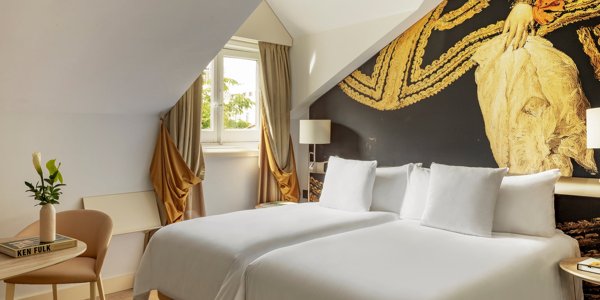 a room with two beds and a chair