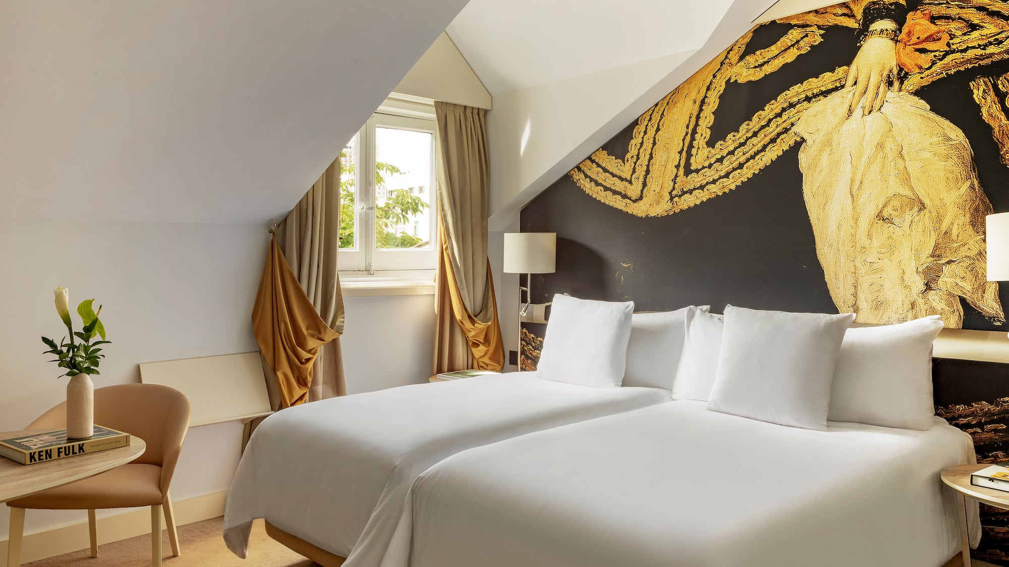 a room with two beds and a chair