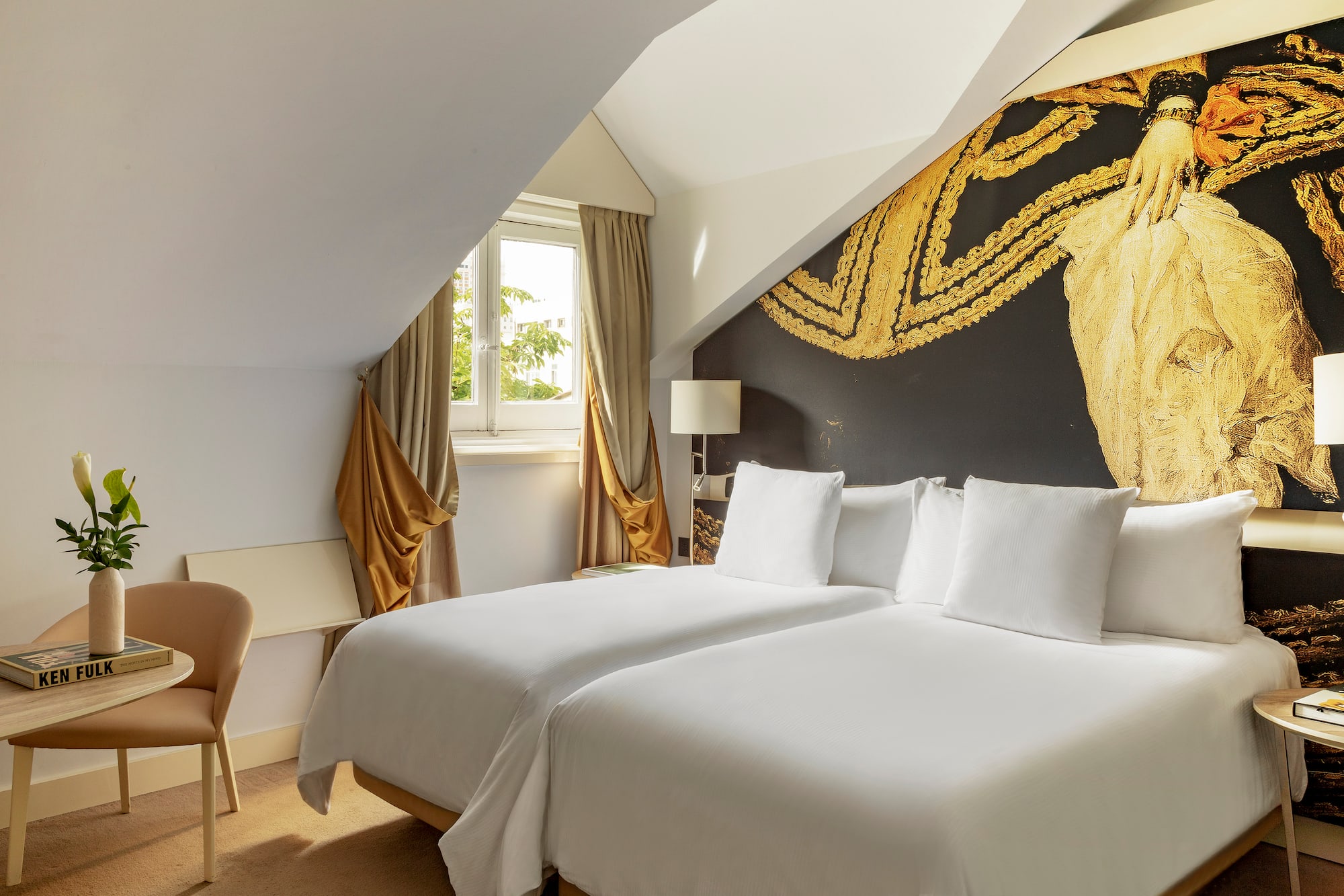 a room with two beds and a chair