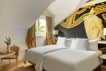 a room with two beds and a chair