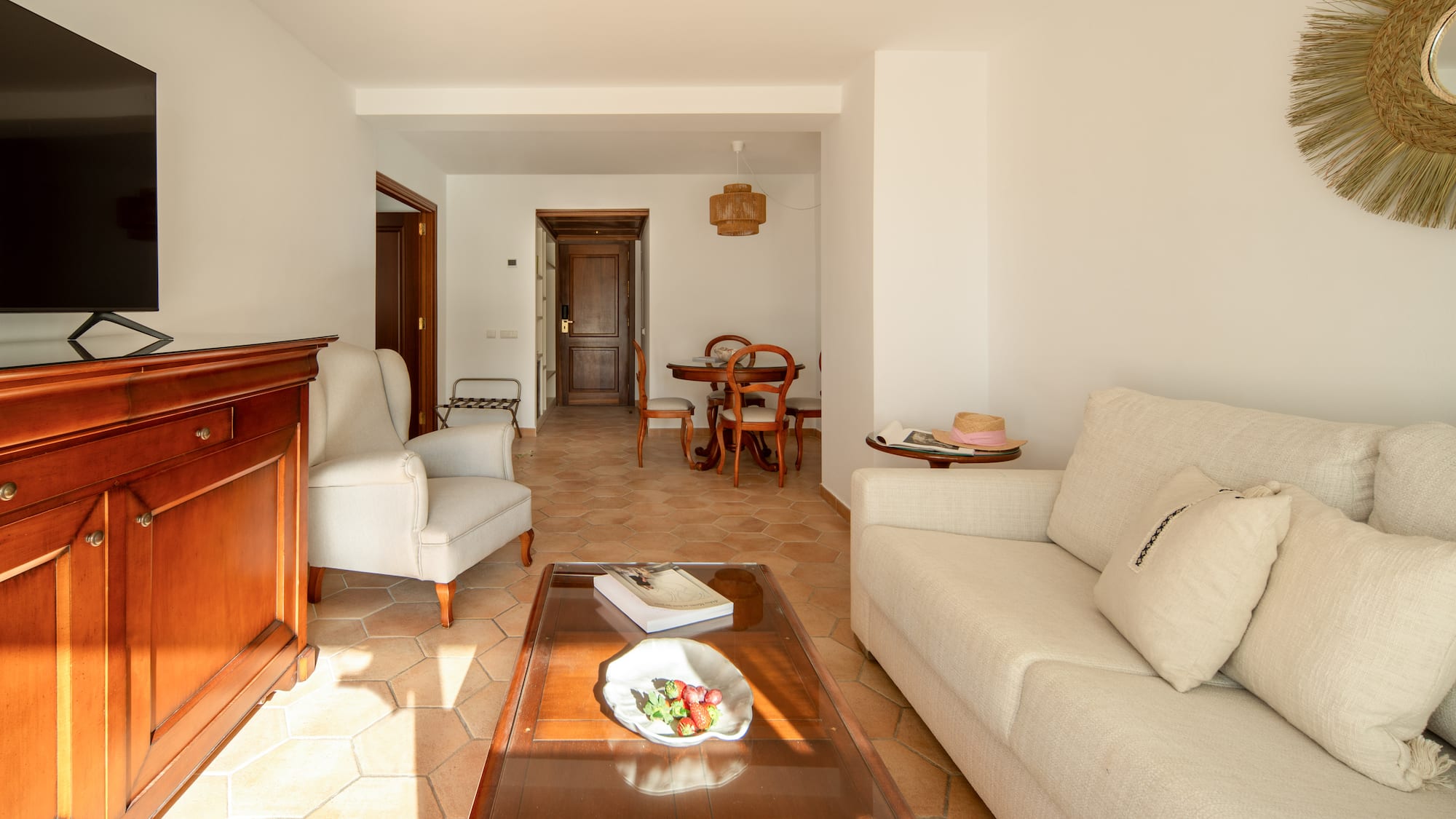 a living room with white furniture and a glass coffee table