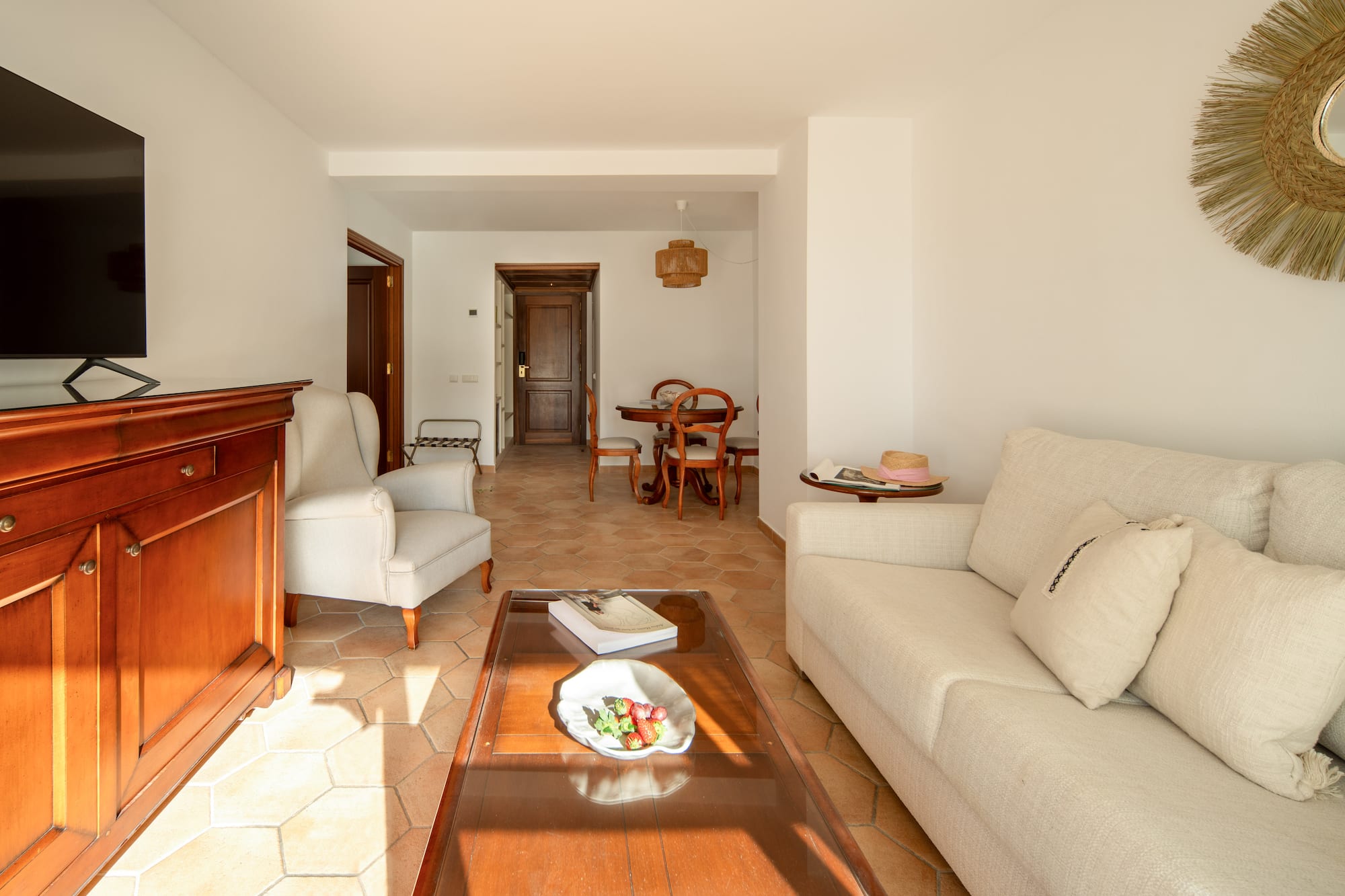 a living room with white furniture and a glass coffee table