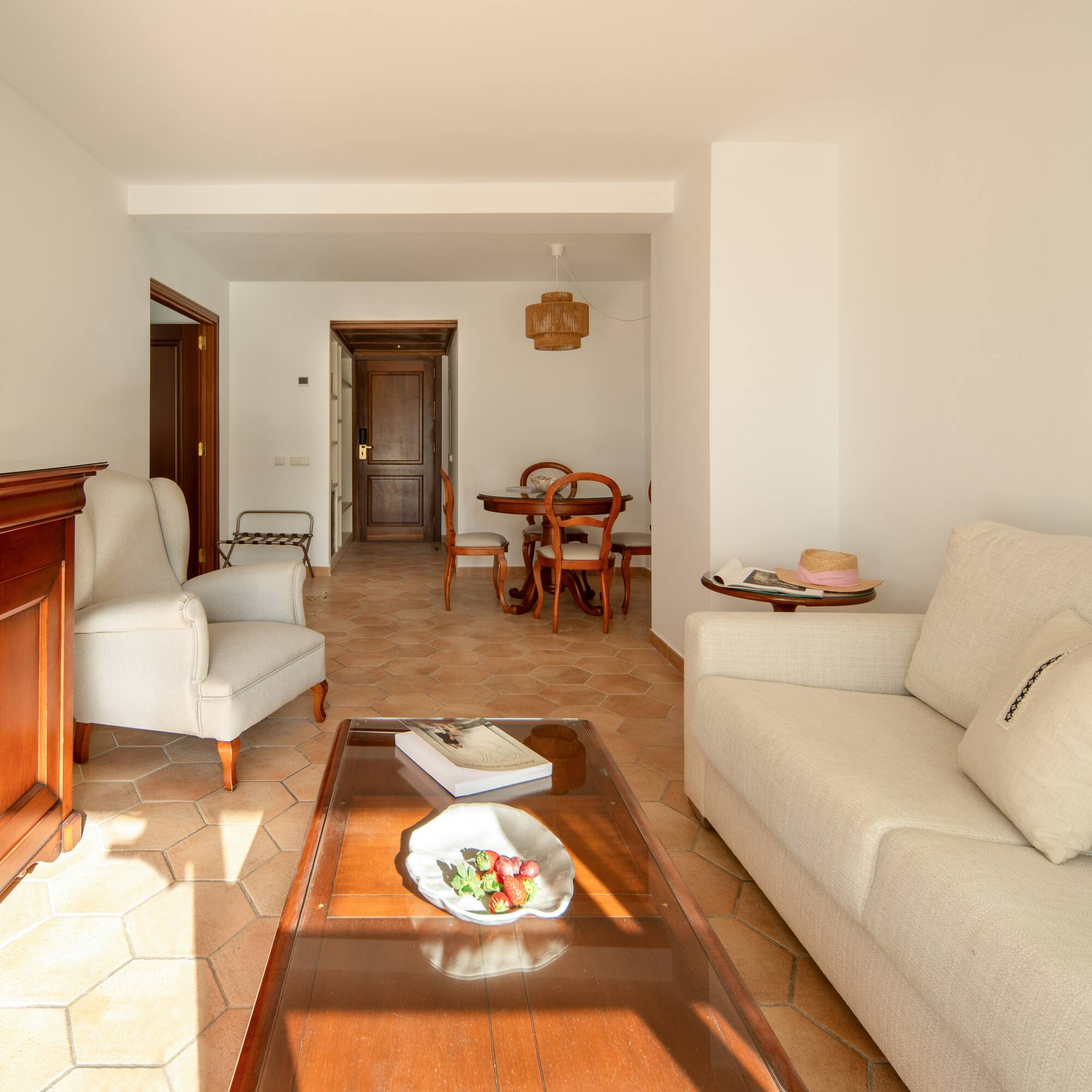 a living room with white furniture and a glass coffee table