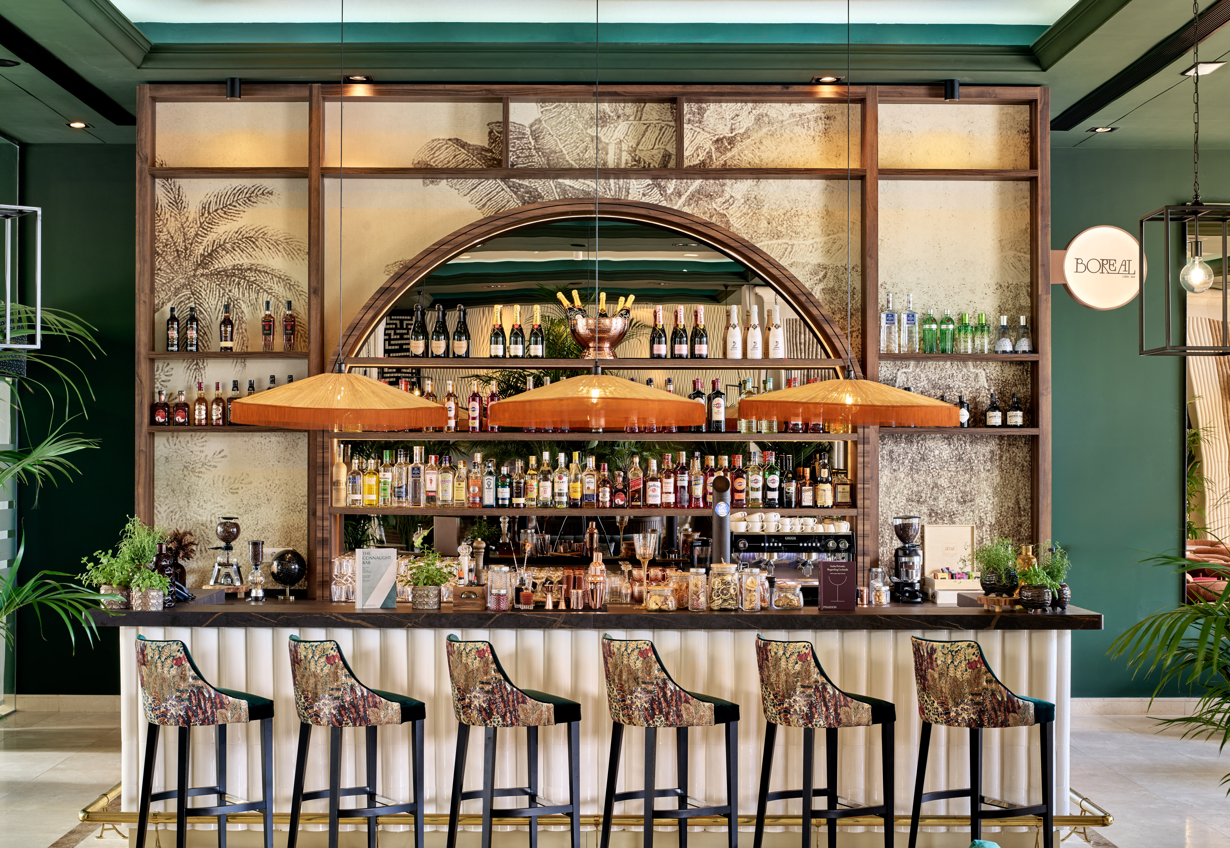 a bar with a row of chairs and bottles