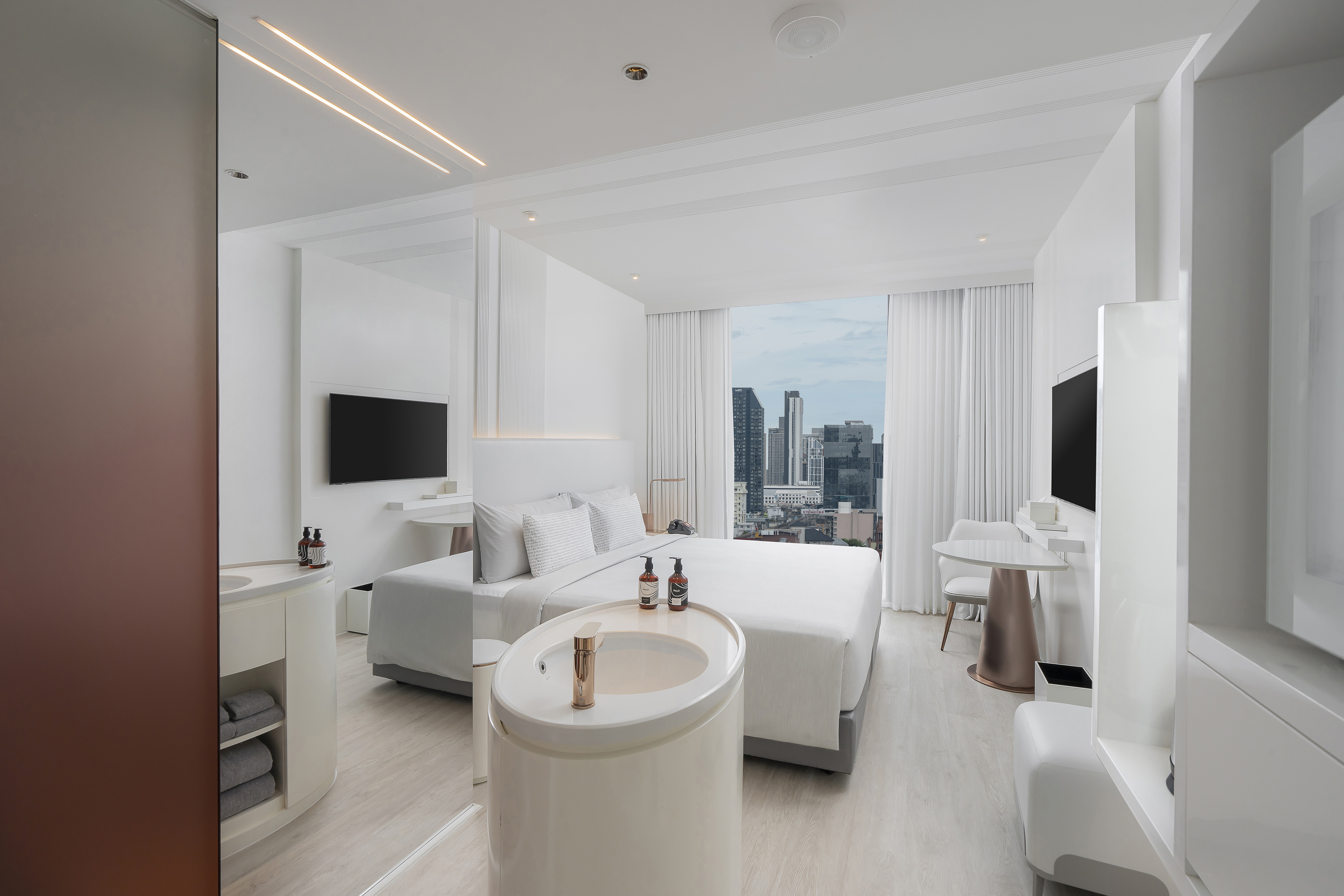 Luxury hotel suite, white decor, city skyline view, modern design bedroom.