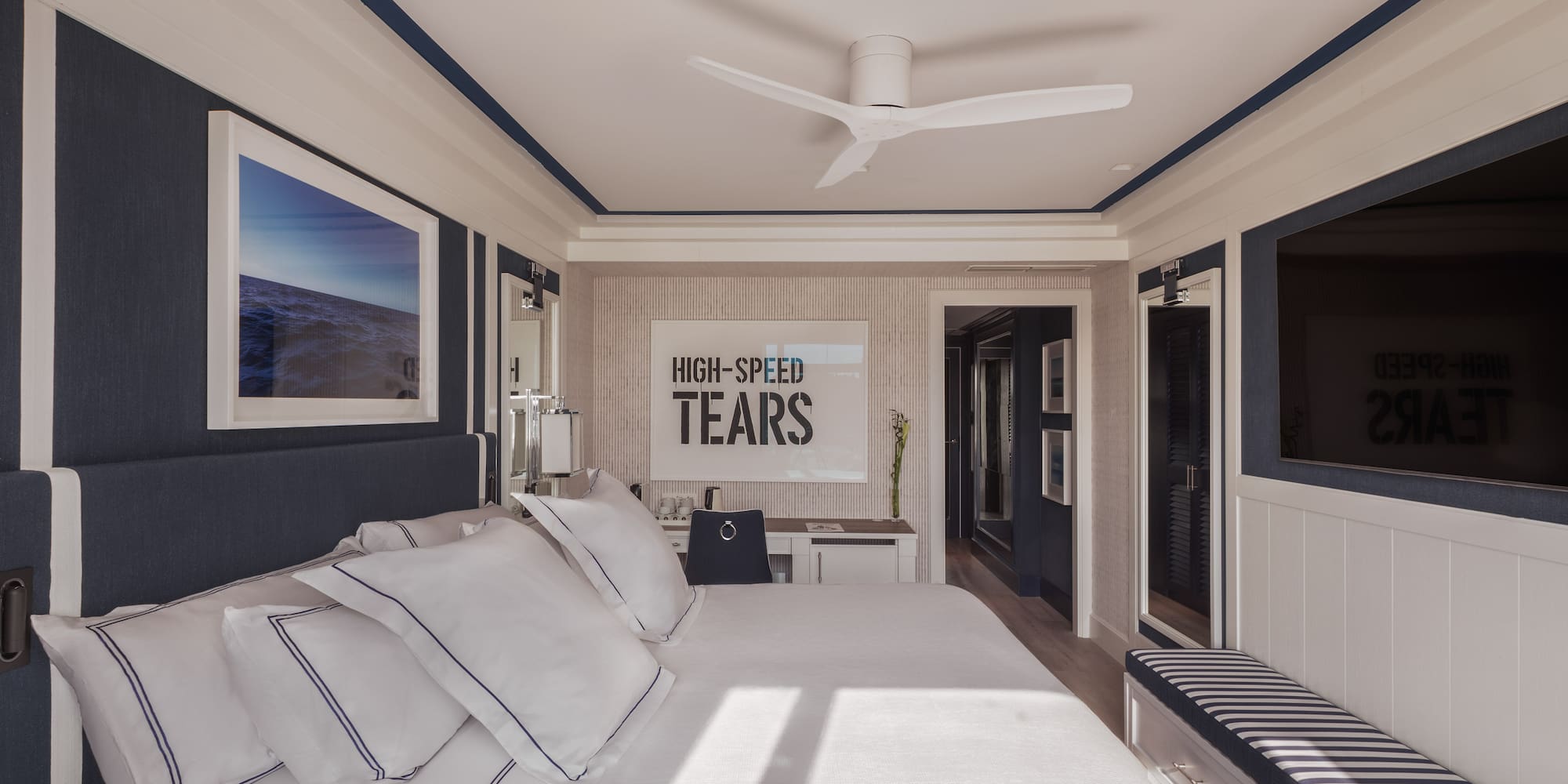 a bedroom with a bed and a ceiling fan