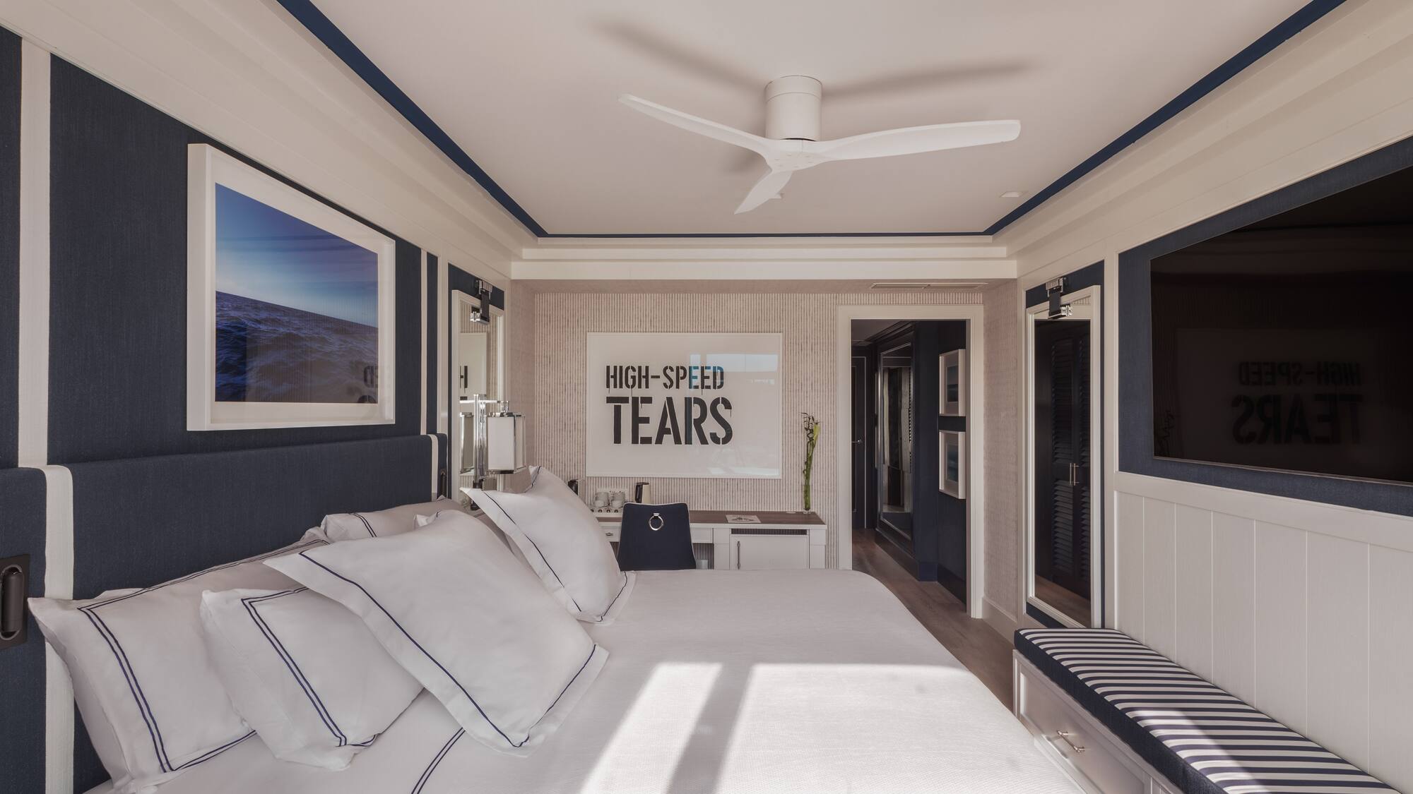 a bedroom with a bed and a ceiling fan