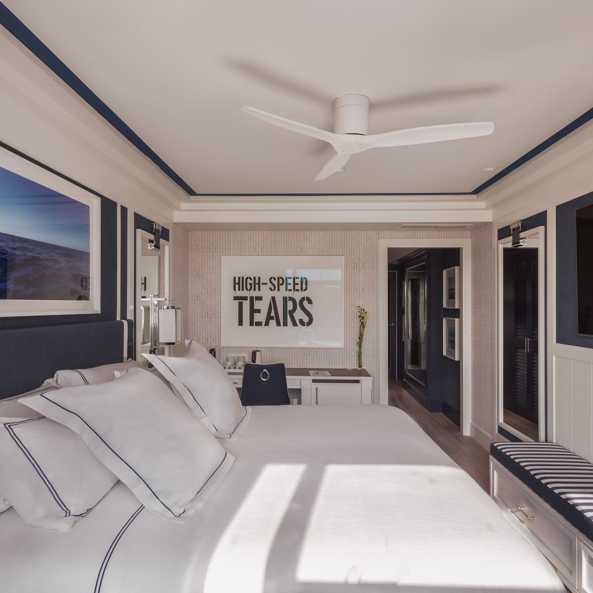 a bedroom with a bed and a ceiling fan