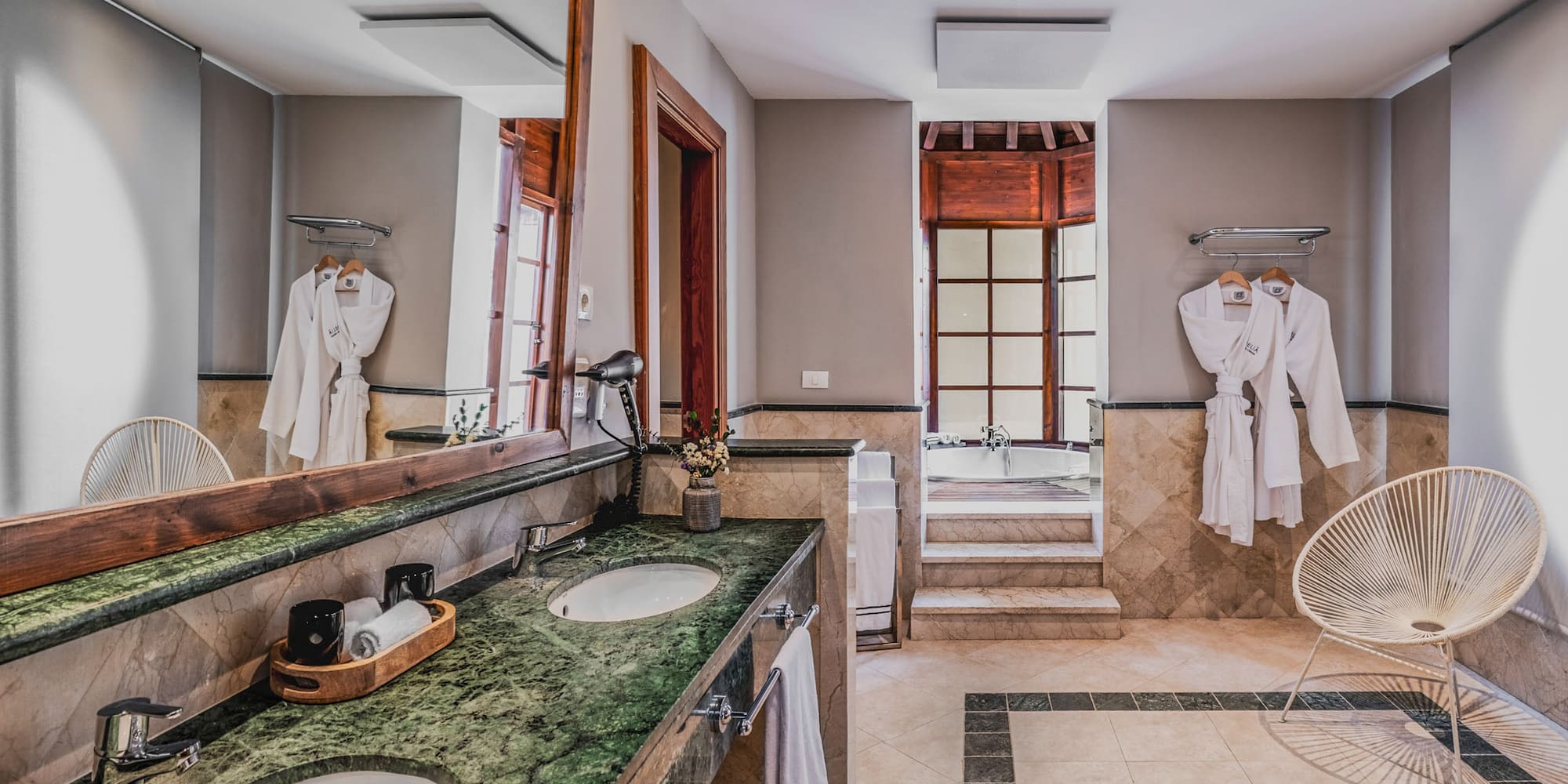 a bathroom with a large mirror and two sinks