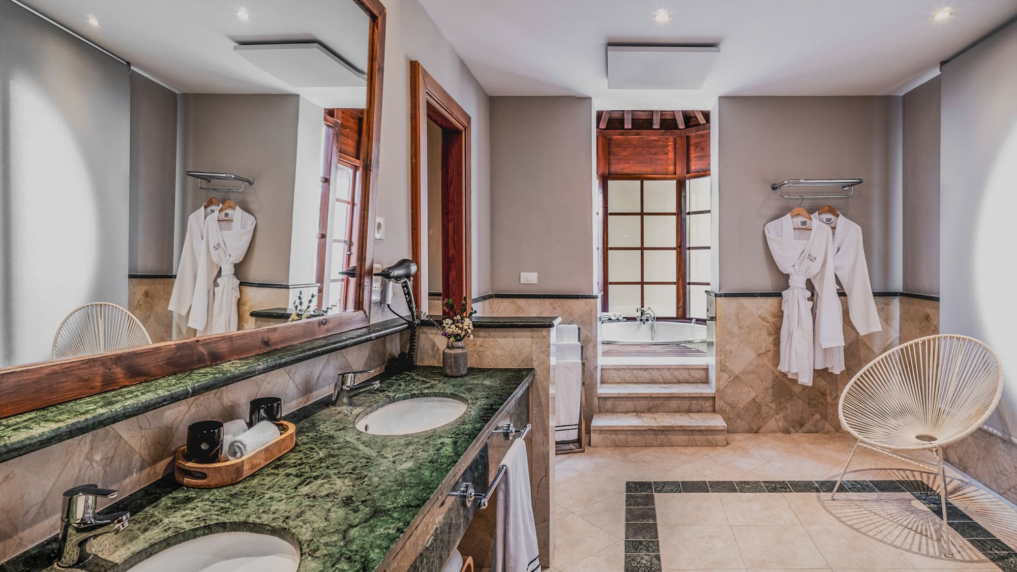 a bathroom with a large mirror and two sinks