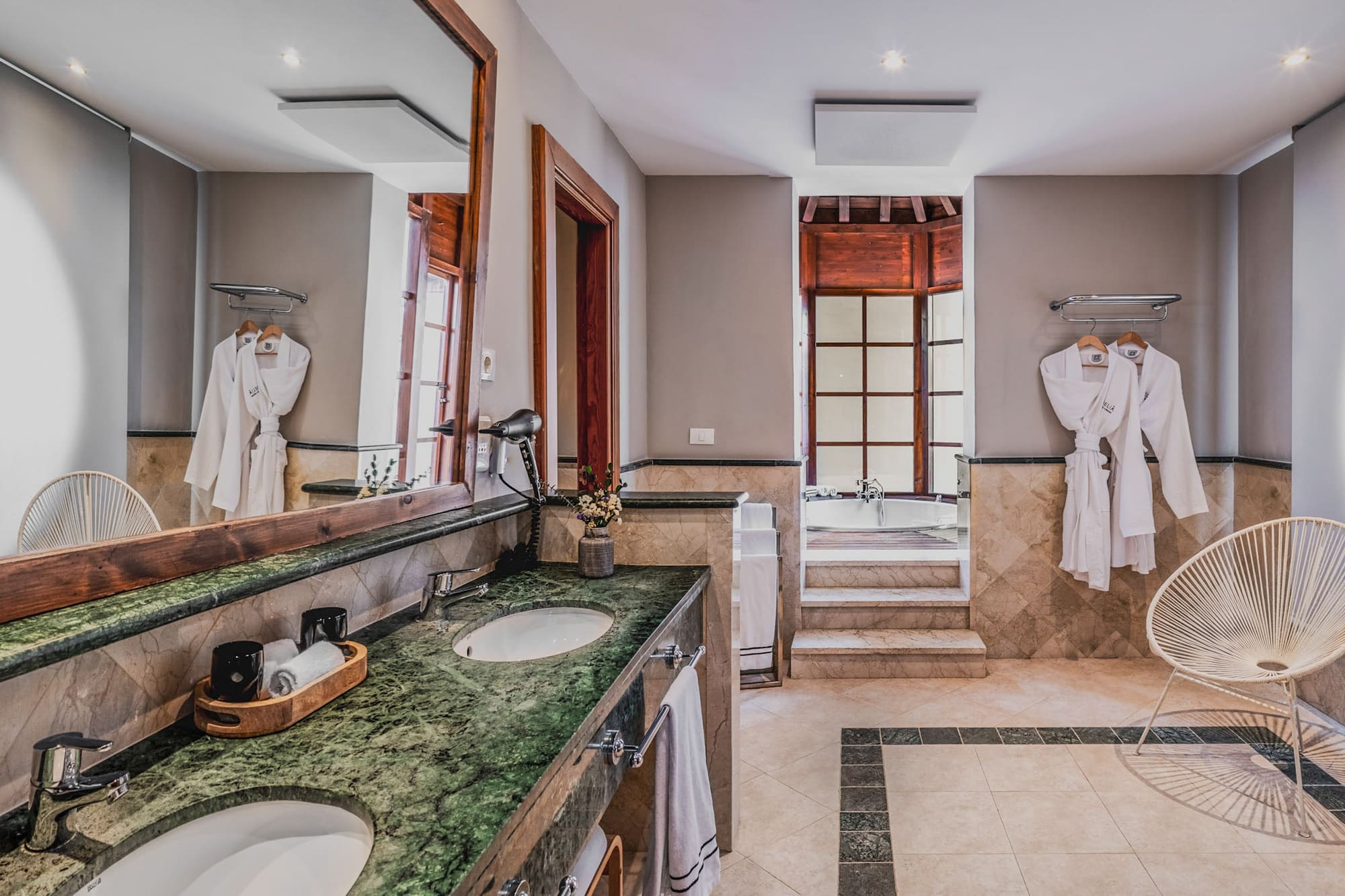 a bathroom with a large mirror and two sinks