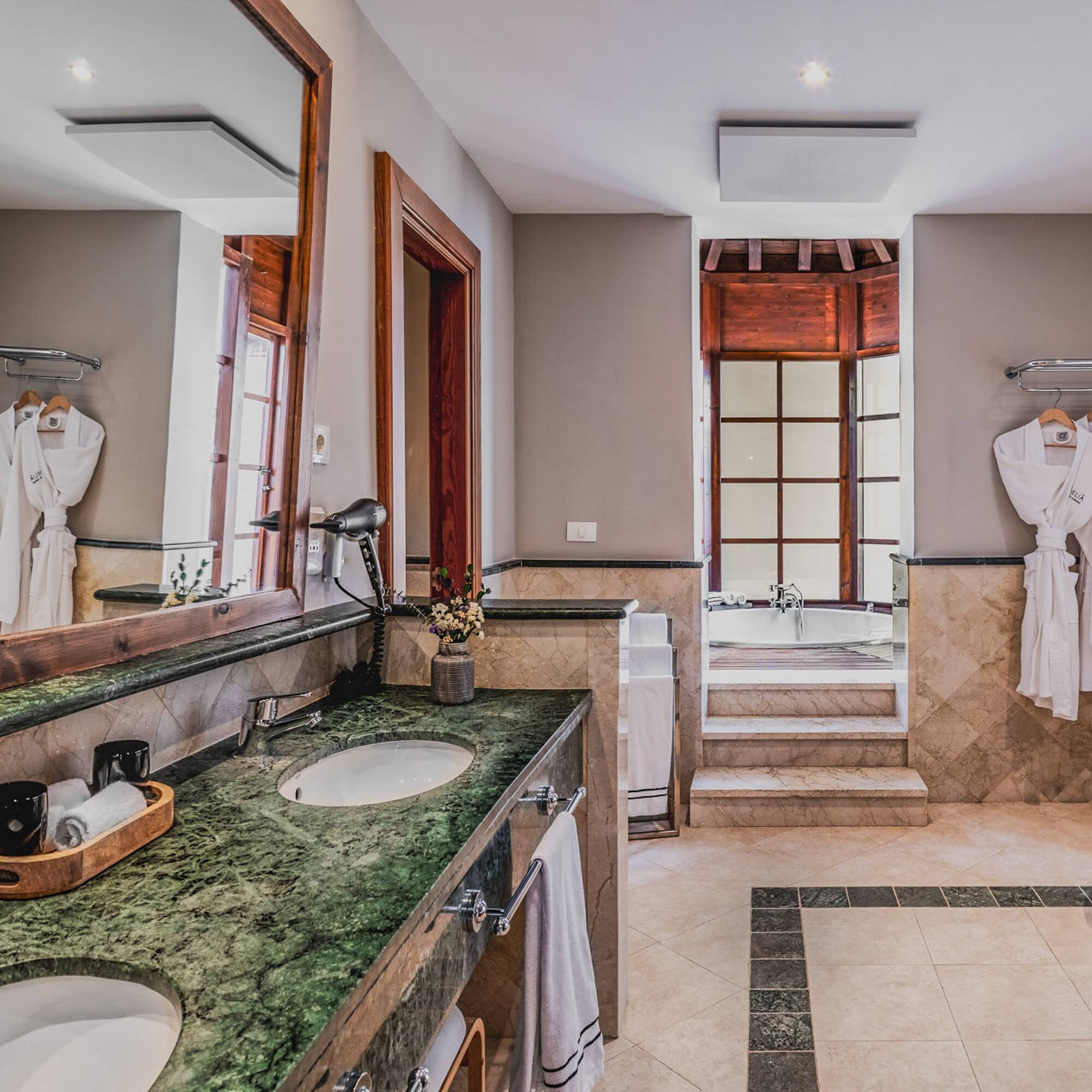 a bathroom with a large mirror and two sinks