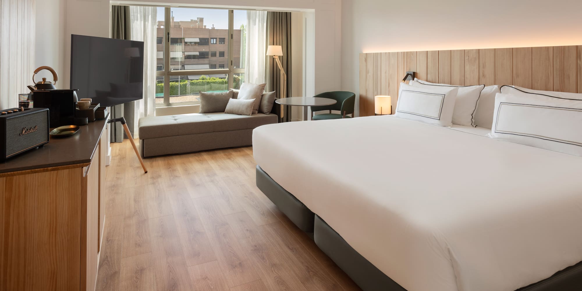 a room with a bed and a television