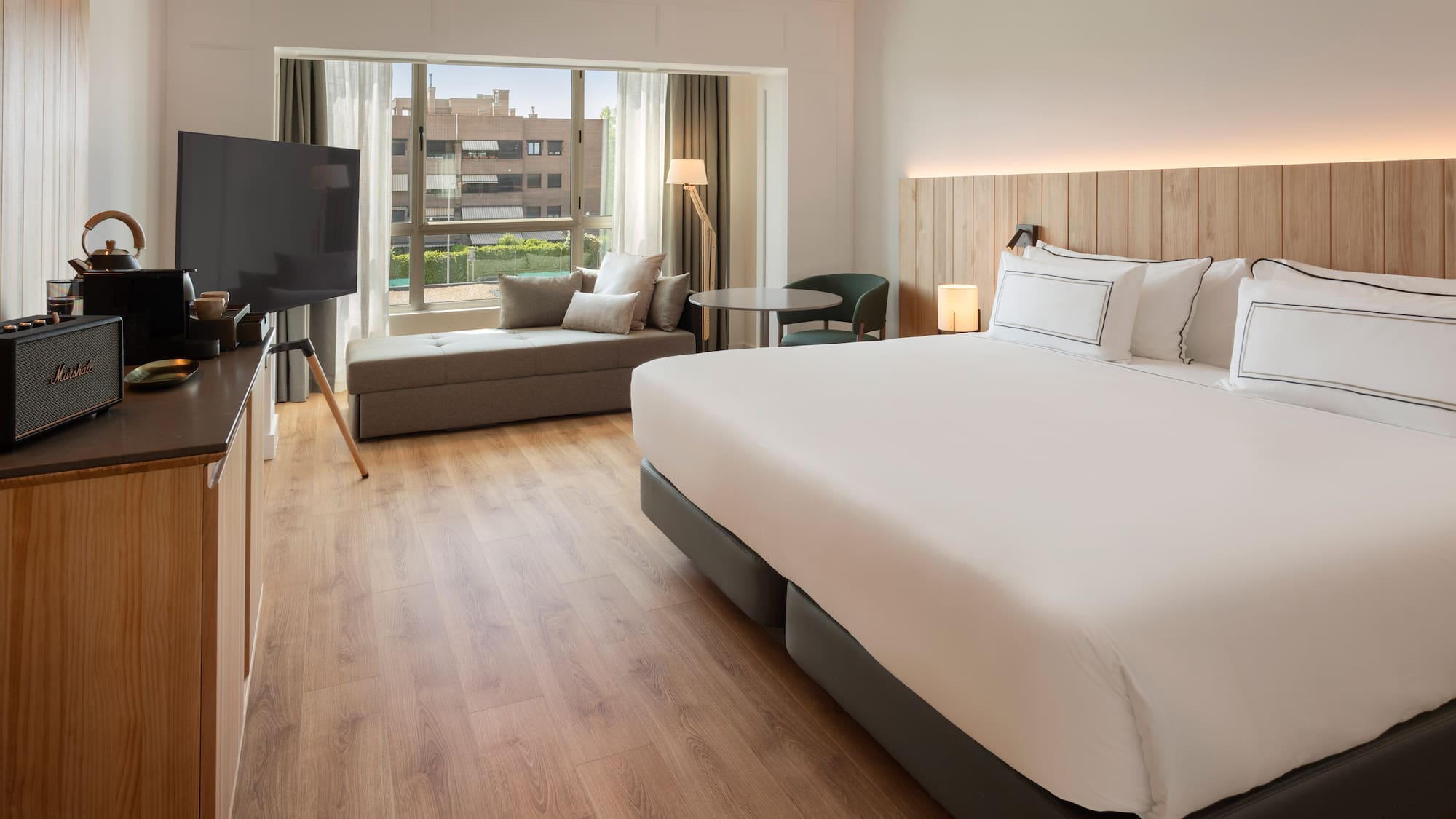 a room with a bed and a television