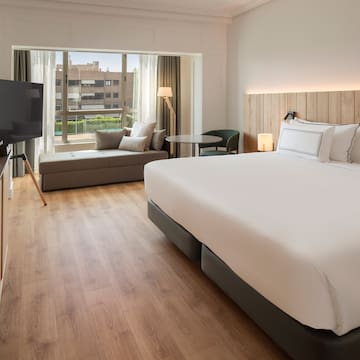 a room with a bed and a television