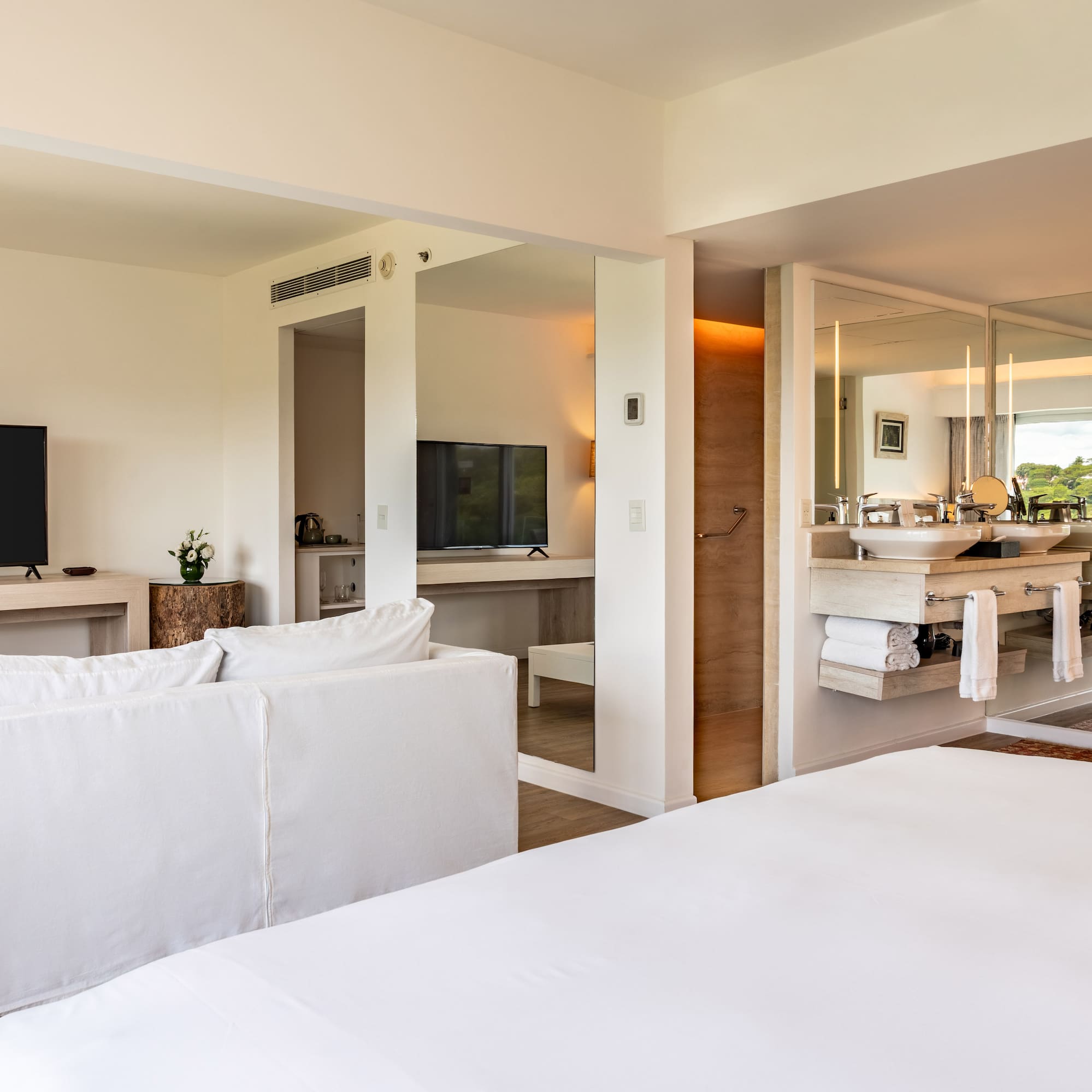 a room with a large bed and a television