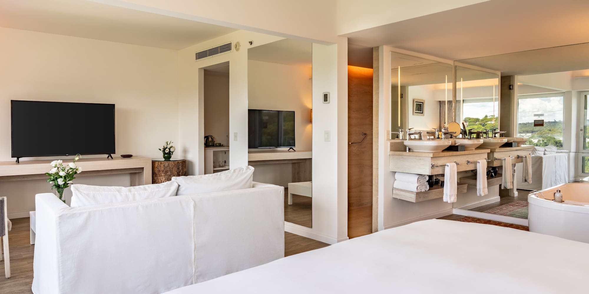 a room with a large bed and a television