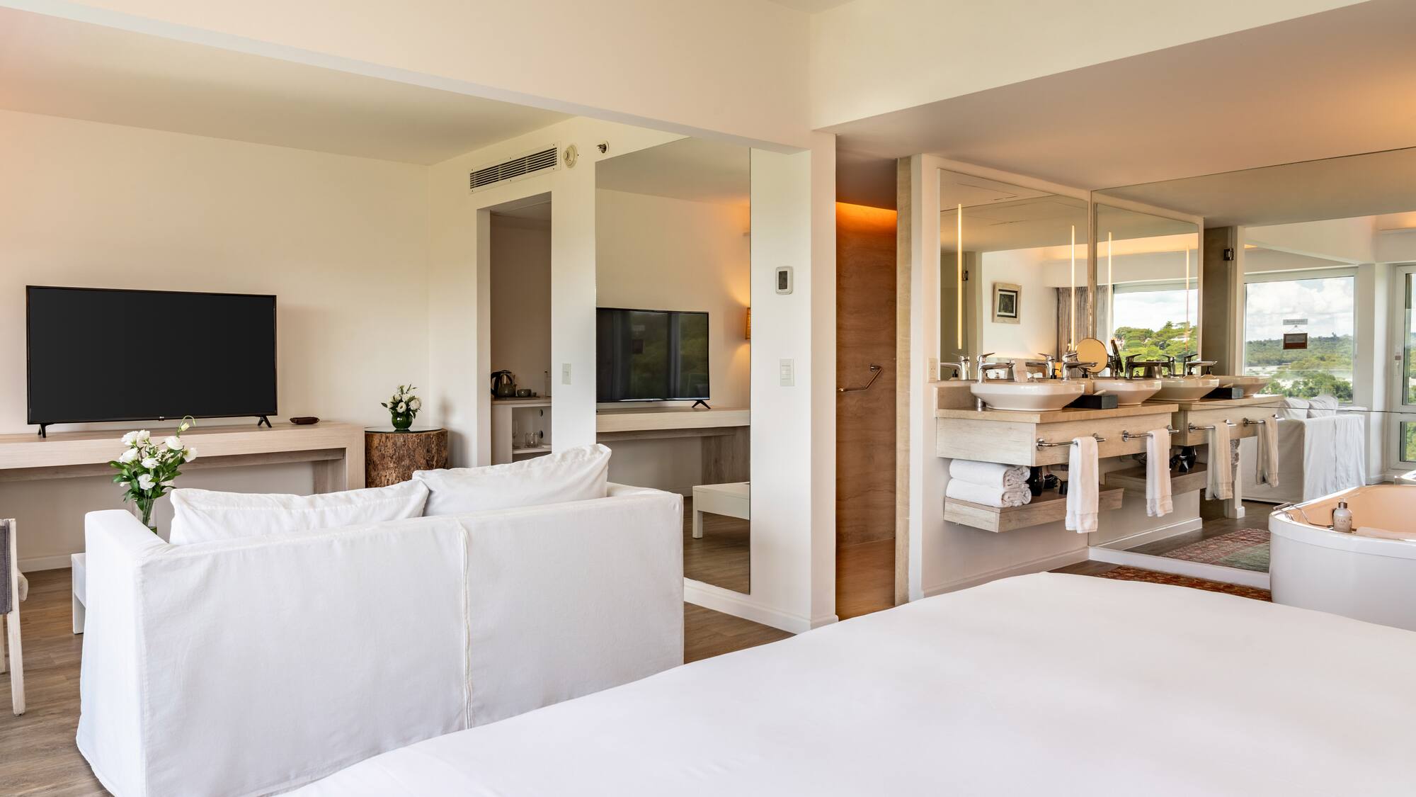 a room with a large bed and a television