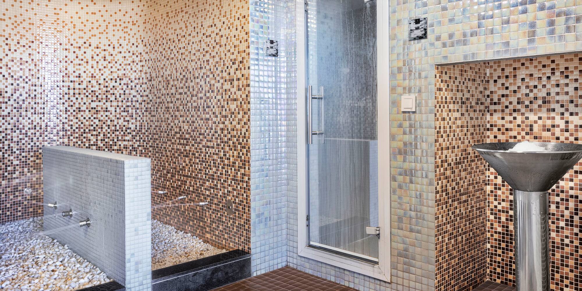 a bathroom with a shower and a shower stall.