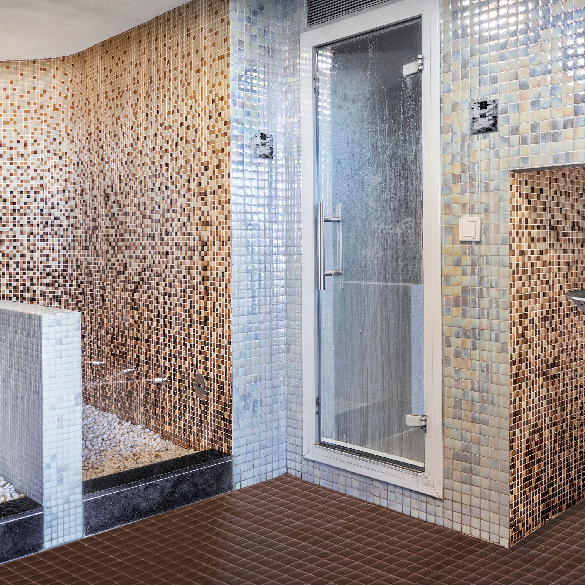 a bathroom with a shower and a shower stall.