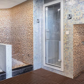 a bathroom with a shower and a shower stall