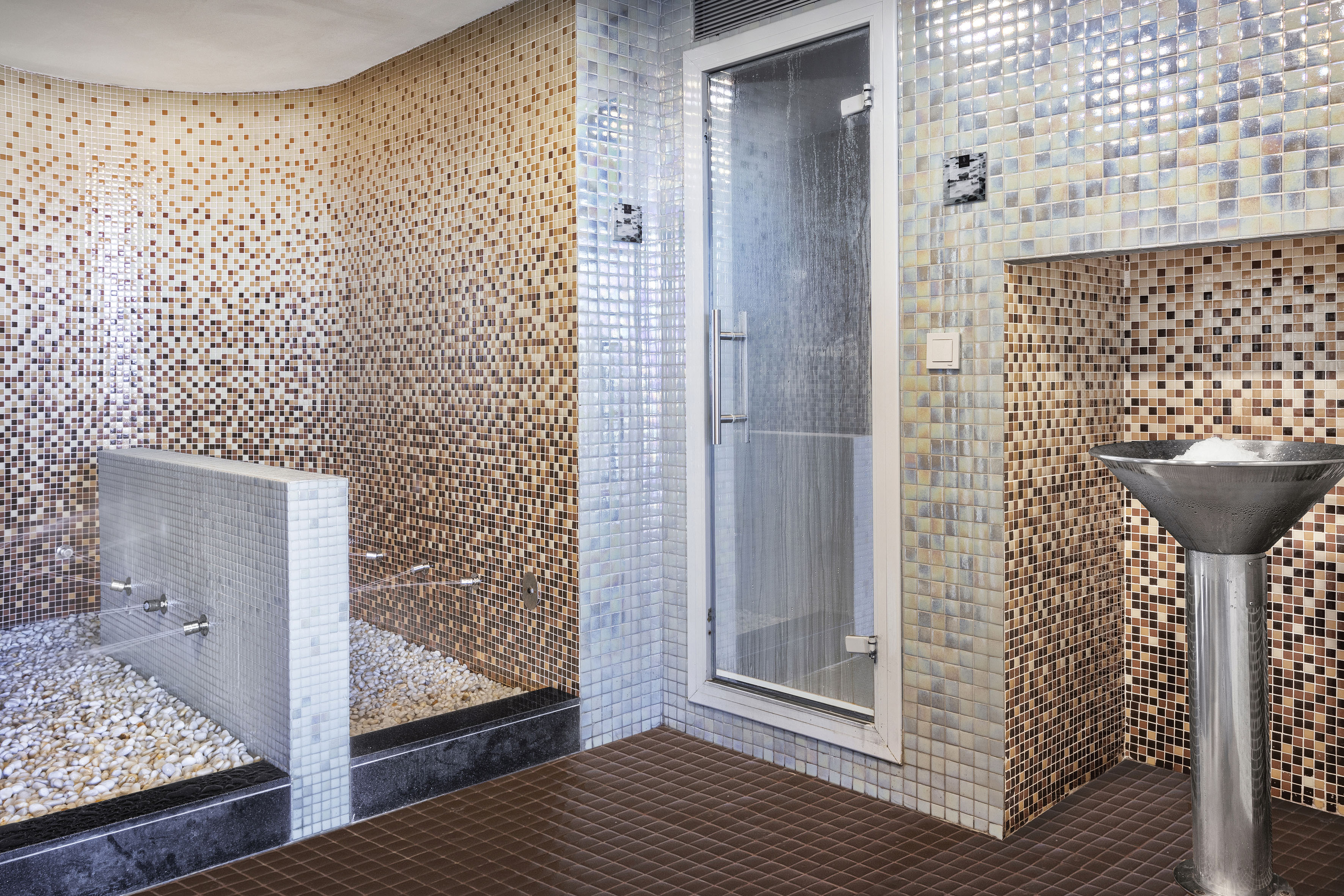 Spa room with mosaic tiles, glass shower, and pebble cold plunge.