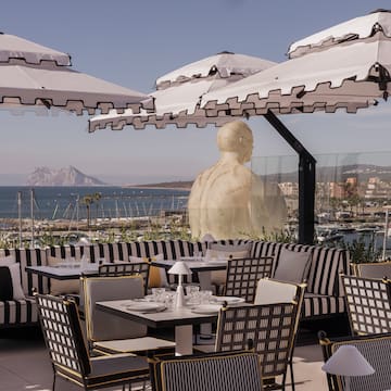 a restaurant with tables and umbrellas