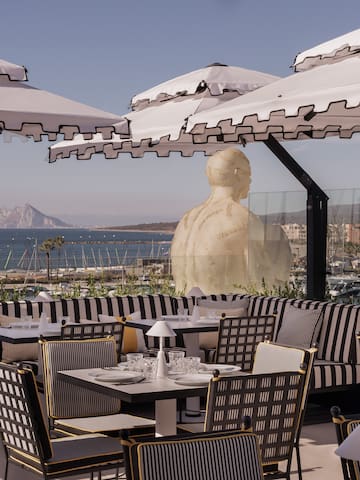 a restaurant with tables and umbrellas