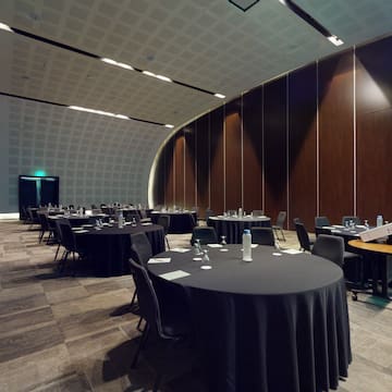 a room with round tables and chairs