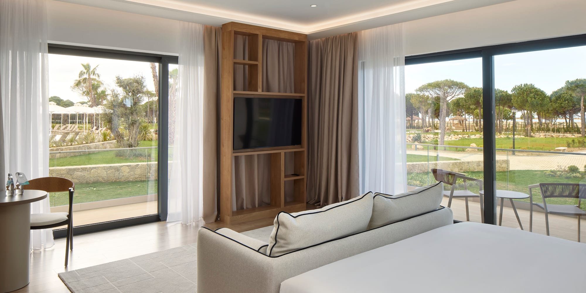 a room with a bed and a television