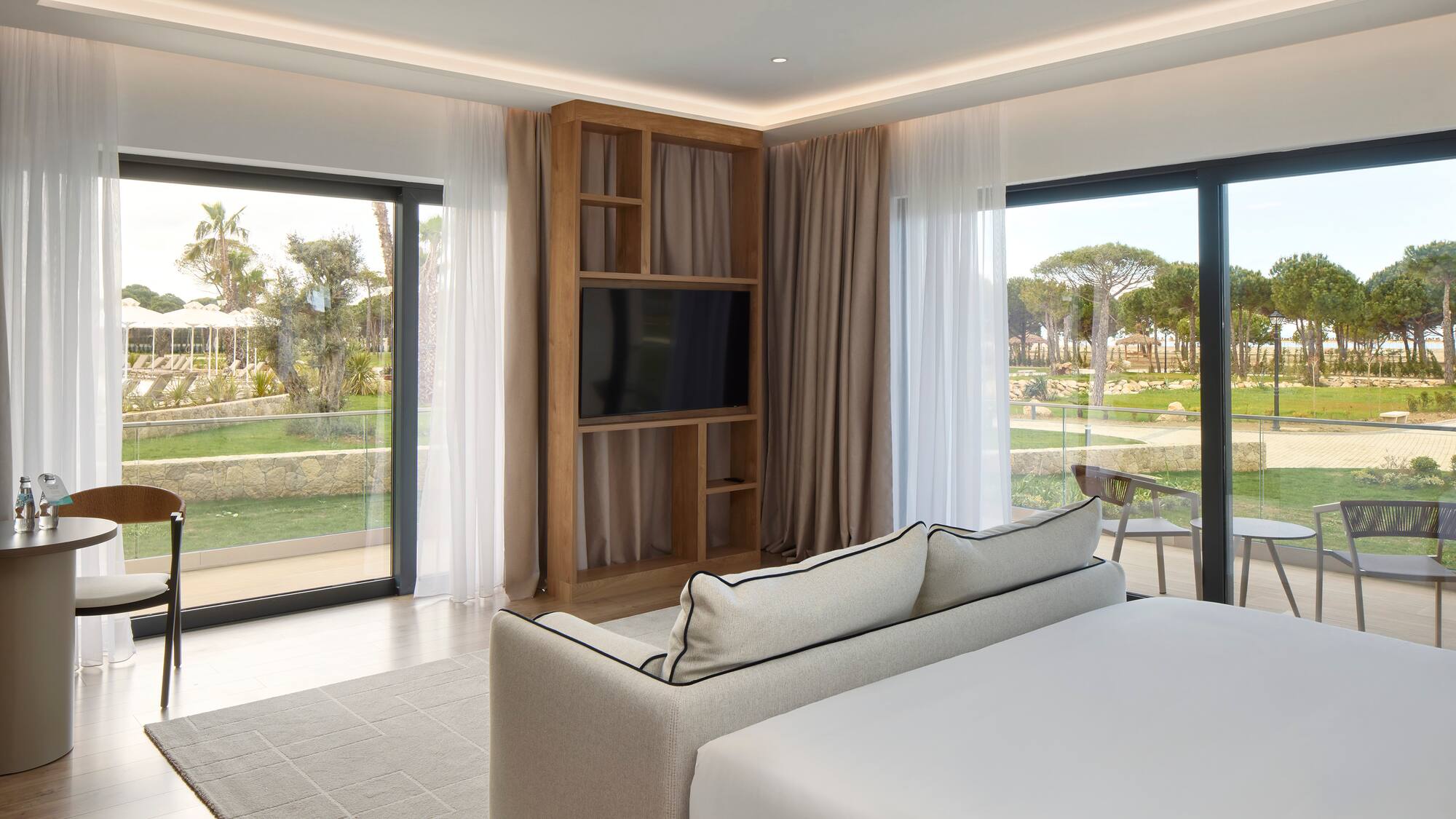 a room with a bed and a television