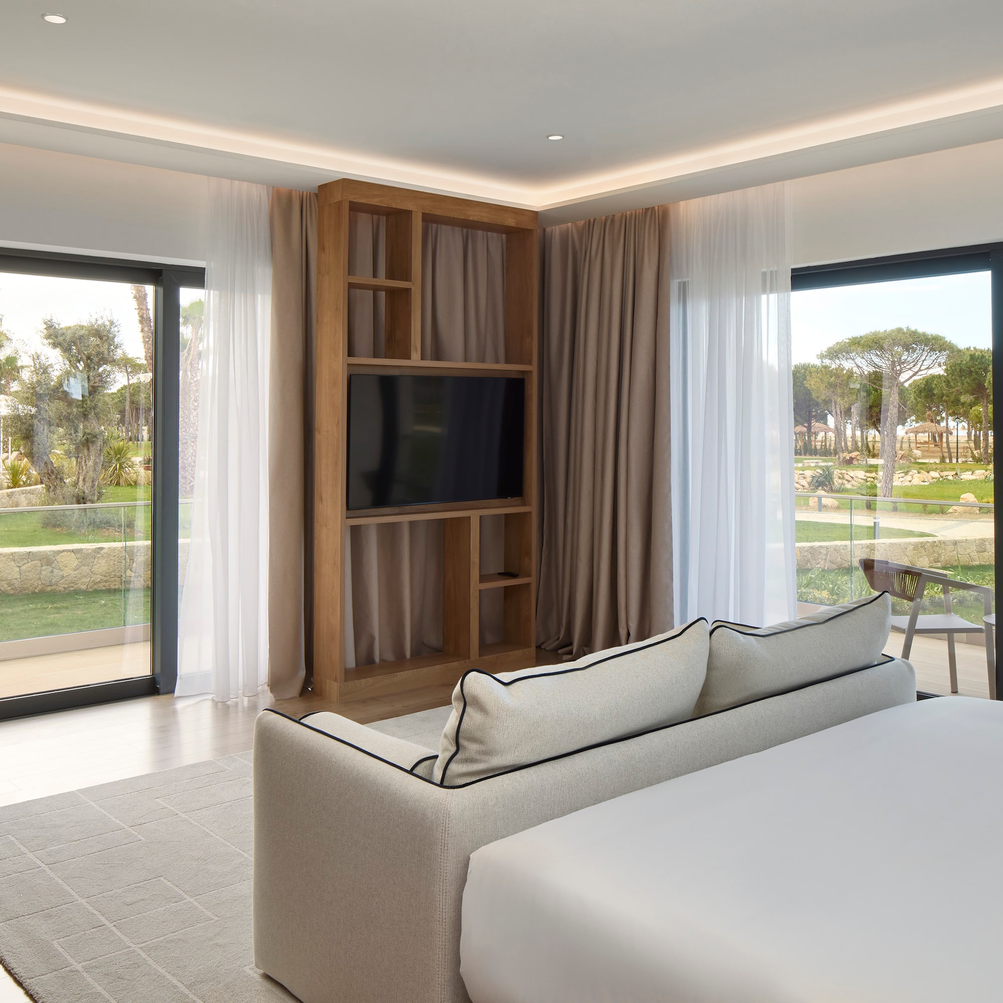 a room with a bed and a television