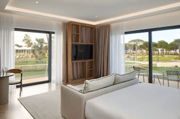 a room with a bed and a television