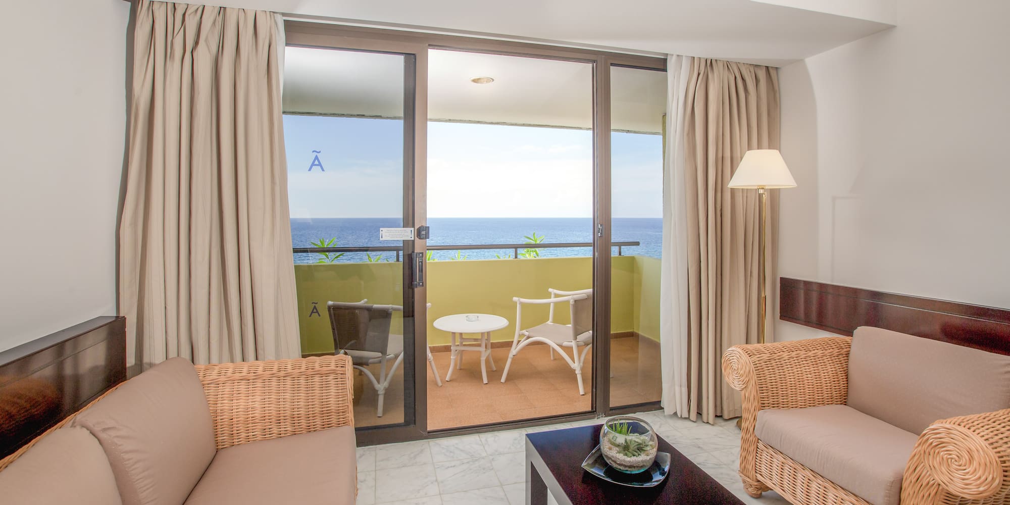 a living room with a glass door and a couch