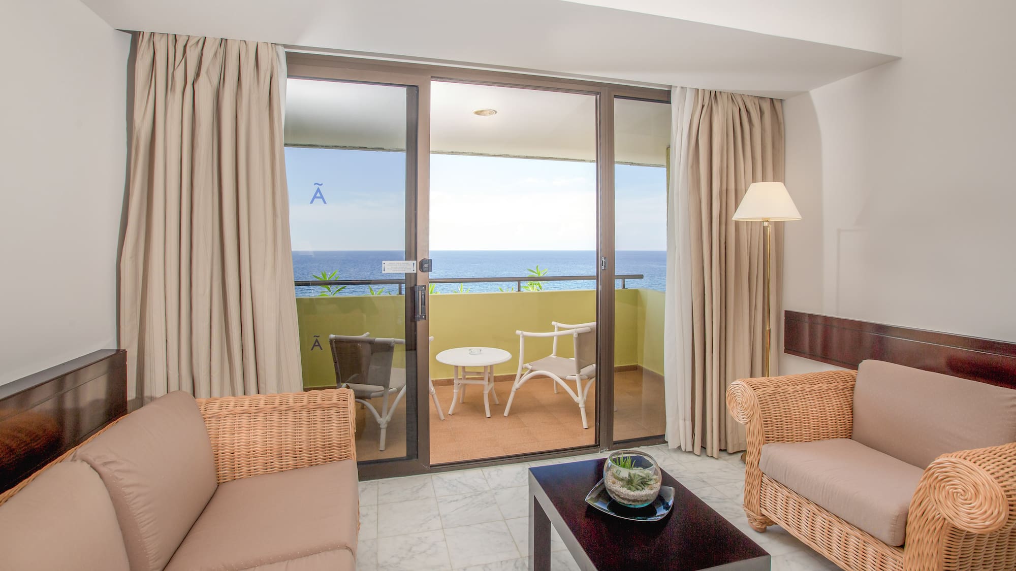 a living room with a glass door and a couch