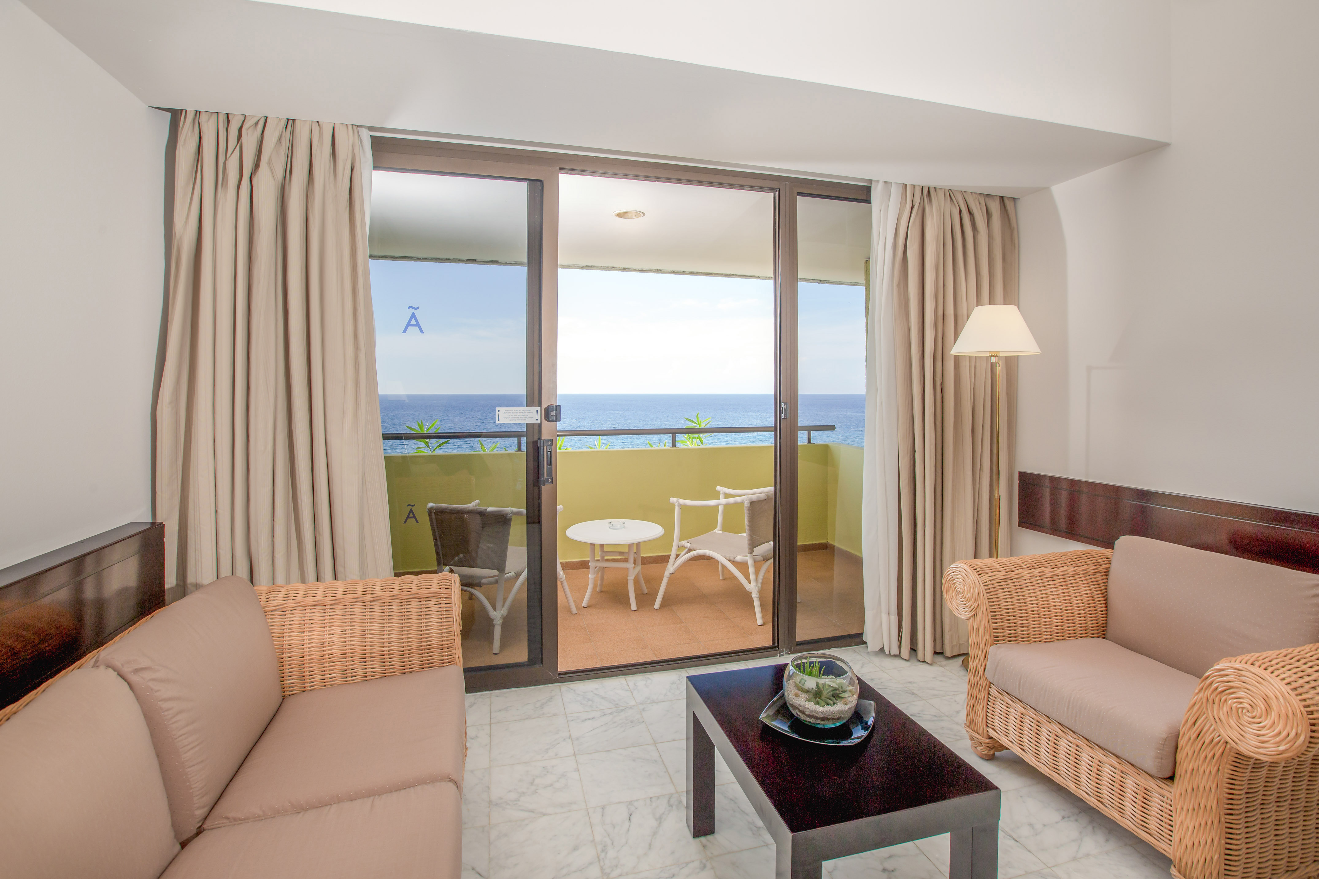 a living room with a glass door and a couch