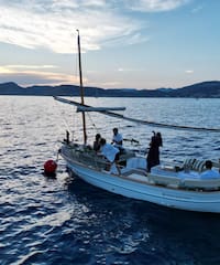 a group of people on a boat in the water