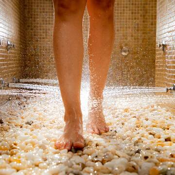 a person's legs walking on a shower