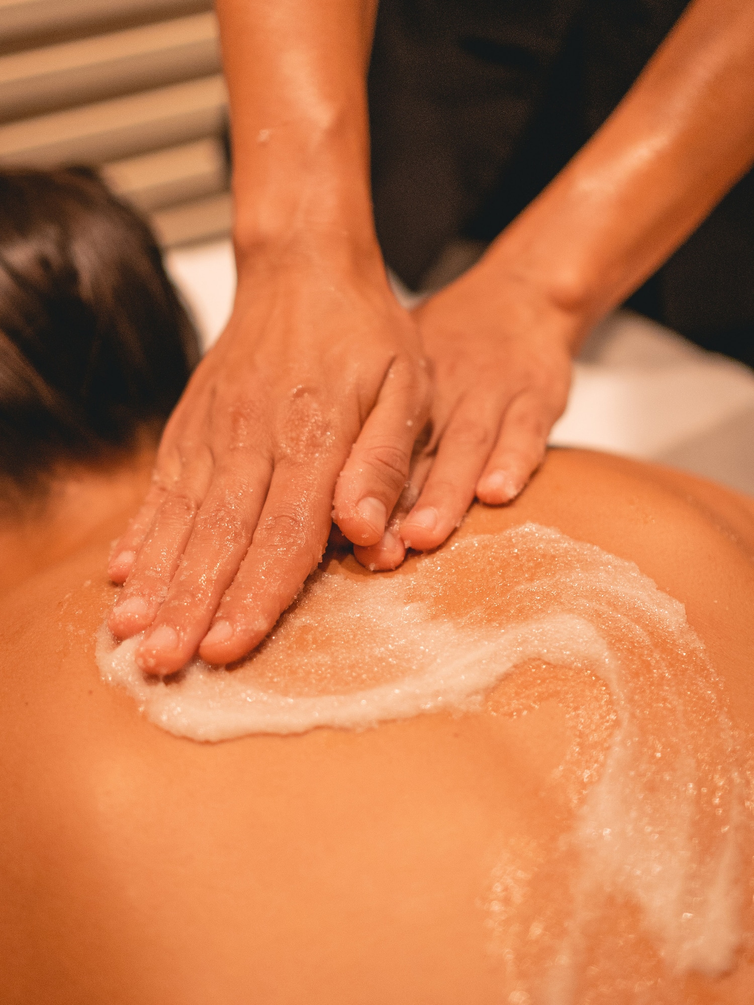 a person's hands on a person's back