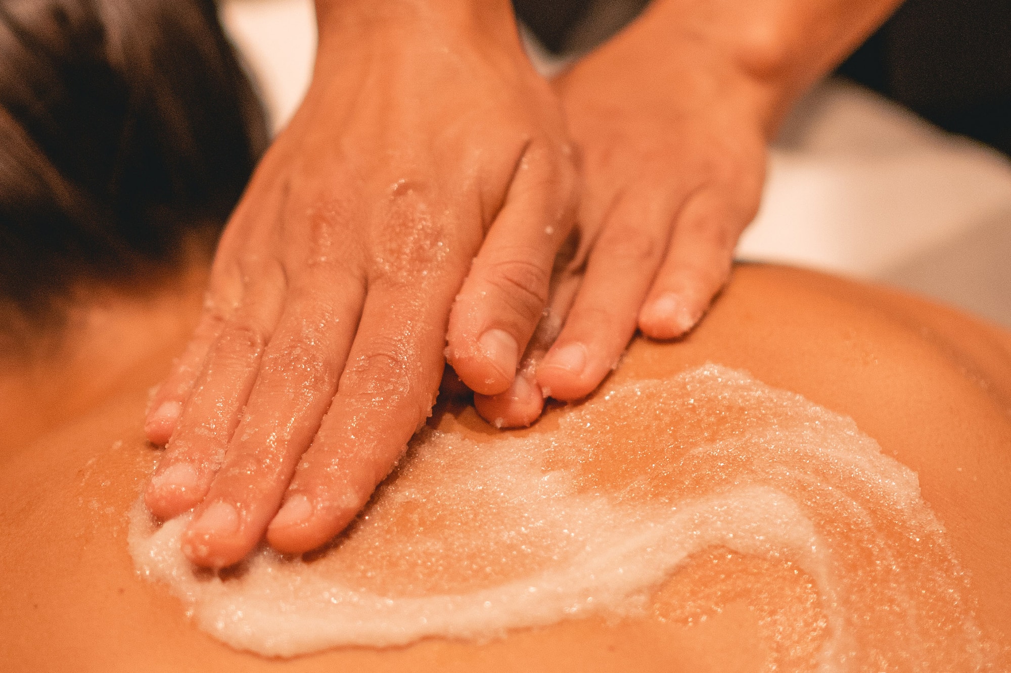 a person's hands on a person's back