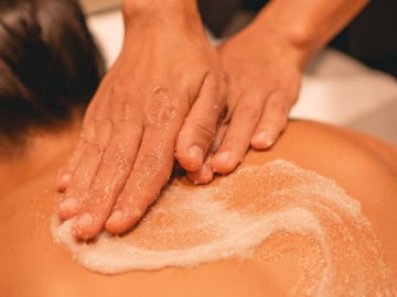 a person's hands on a person's back