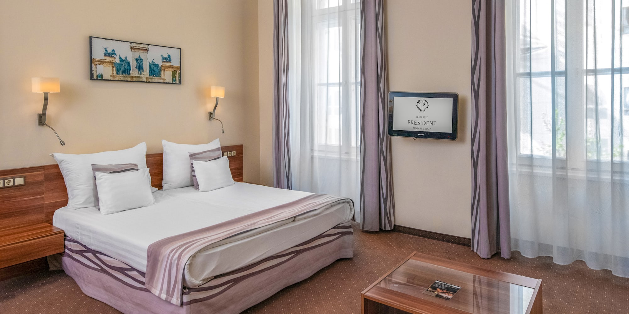 a room with a bed and a television